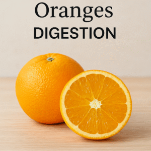 A whole orange and a halved orange on a light wooden surface